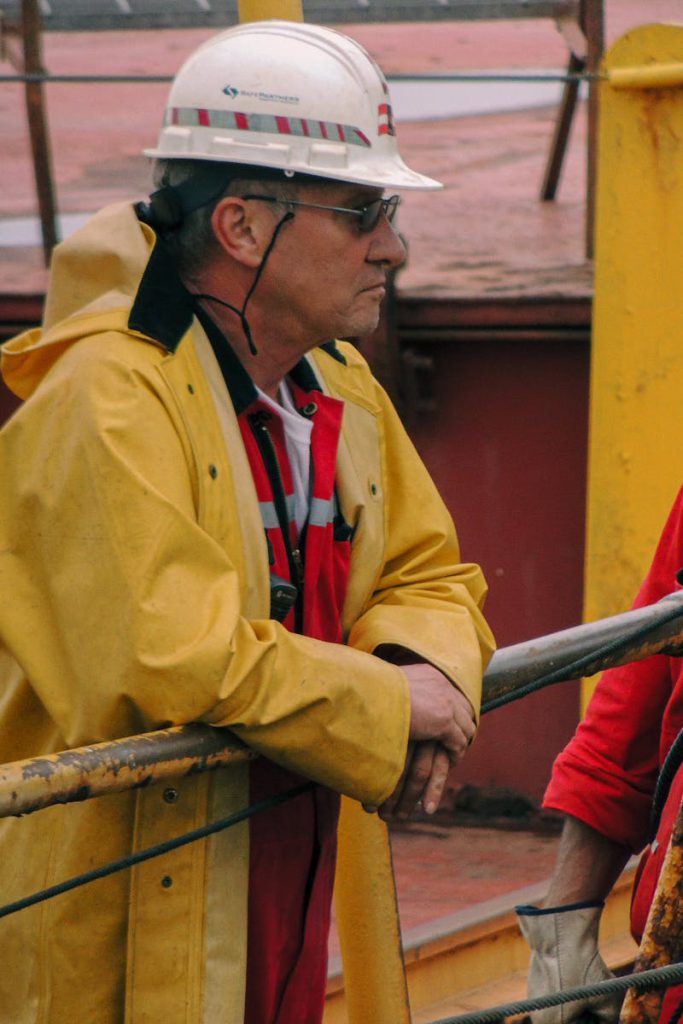Men in safety gear managing ship operations on deck in Mackinaw City.